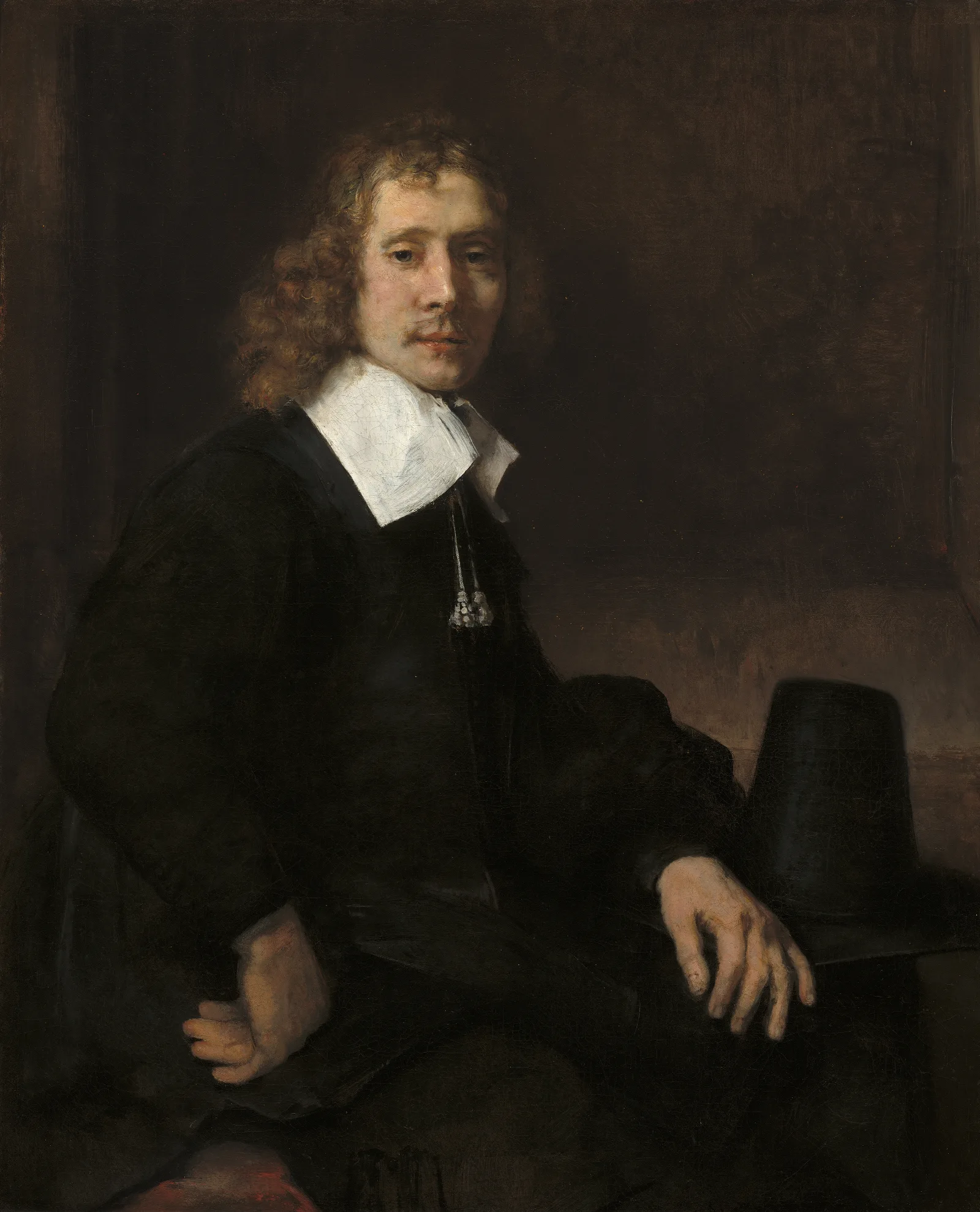 A Young Man Seated At A Table Possibly Govaert Flinck Wall Art by Rembrandt van Rijn - Canvas Print