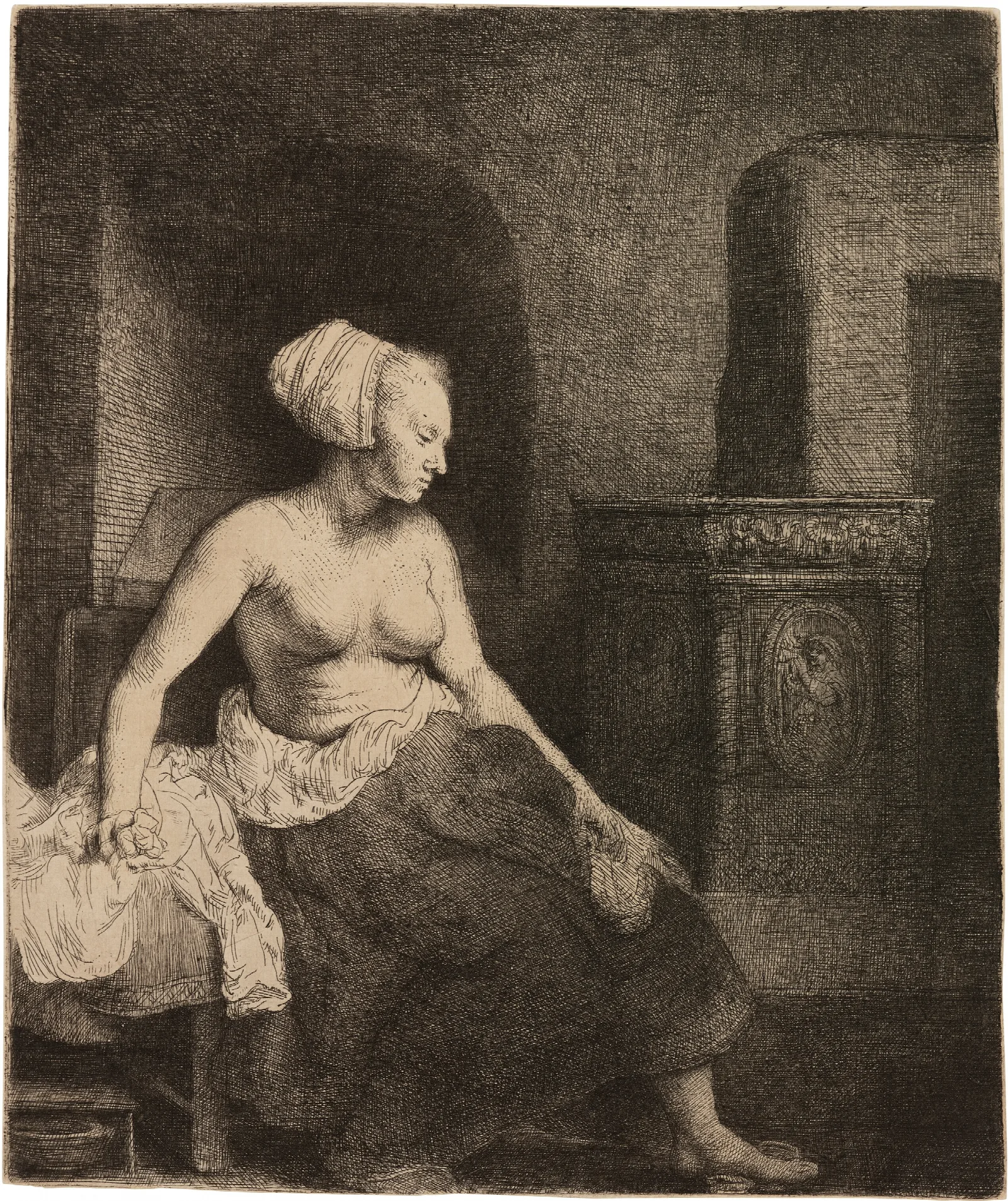 Woman Sitting Half Dressed Beside A Stove Wall Art by Rembrandt van Rijn - Canvas Print