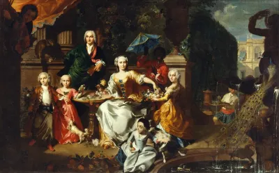 A Family Group On A Terrace In The Grounds Of A Villa