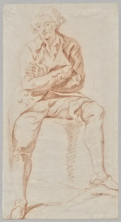 A Man Seated On The Edge Of A Table