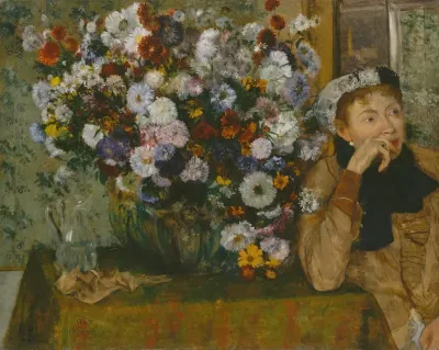 A Woman Seated Beside A Vase Of Flowers