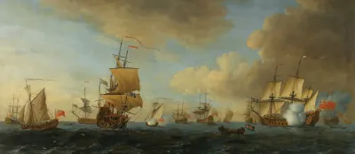 An English Frigate Under Sail Firing A Gun With Shipping At Anchor And Under Sail