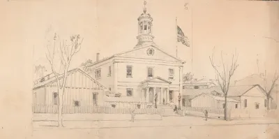 Courthouse Or Town Hall Surrounded By Homes And Outbuildings American Flag Flying Over Roof At Right