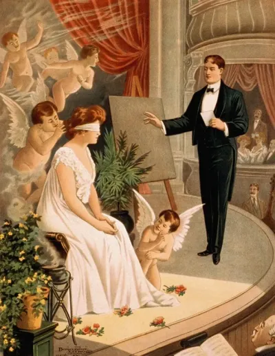 Hypnotist And Blindfolded Woman With Angels On Stage