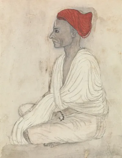 Man In A Red Turban Sitting Crosslegged