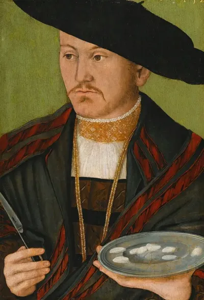 Portrait Of A Man Cutting Scallops With A Fish Knife
