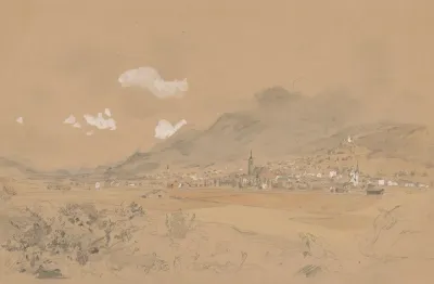 View Of A Village Below The Mountains