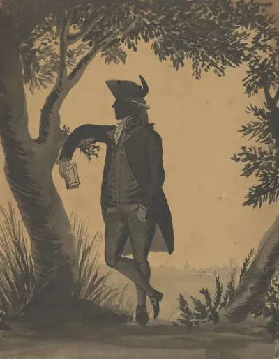 Young Man Leaning Against A Tree With A Book