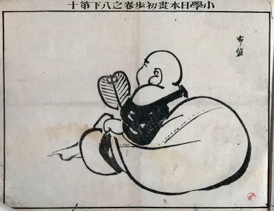 A baby holding a fan, leaning on a cushion, seen from behind