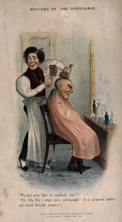 A barber brushing the hair of a man who has very little hair