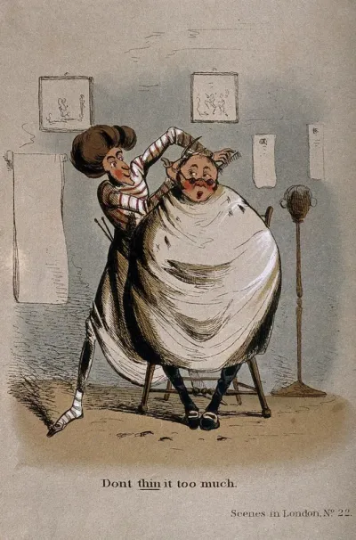 A barber cutting the hair of a man who is largely bald