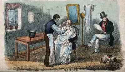 A barber shaving a man; another man sits in the background awaiting his turn