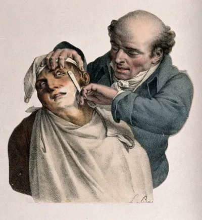 A barber shaving a man who looks fearful