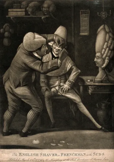 A barber shaving a man