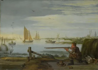 A bird hunter on a riverbank