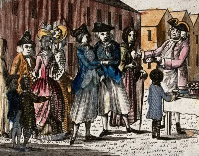A biscuit seller is offering his wares to a crowd of people