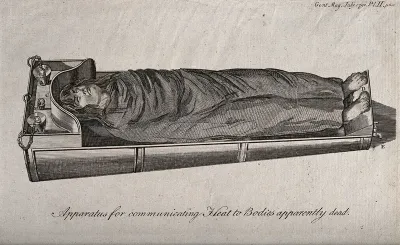 A body covered with a blanket lying on a heated bath for the purpose of resuscitation
