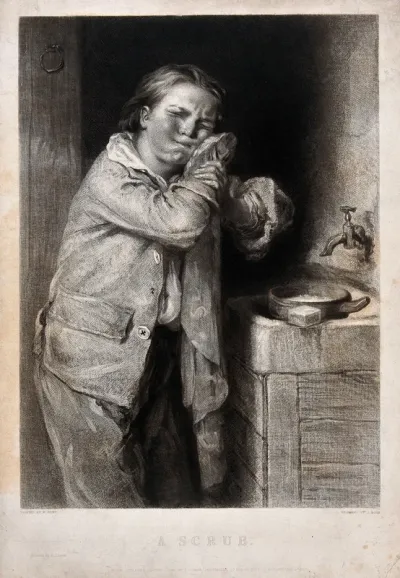 A boy patting his face dry after washing
