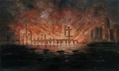 A burning building seen from the water at night