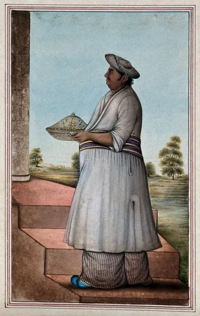 A butler carrying a serving dish
