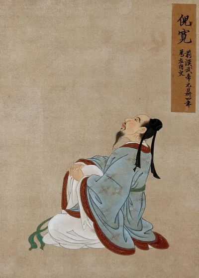 A Chinese figure, seated, profile view, wearing pale blue robes with light brown border