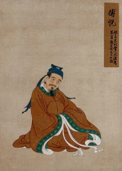 A Chinese figure, seated, smiling with light brown robes and black hat