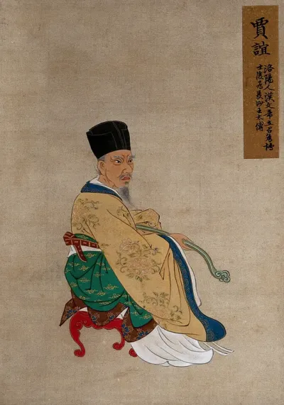 A Chinese figure, seated, wearing beige robes and tall black hat