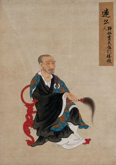 A Chinese figure, seated, wearing black robes with a black, with flywhisk
