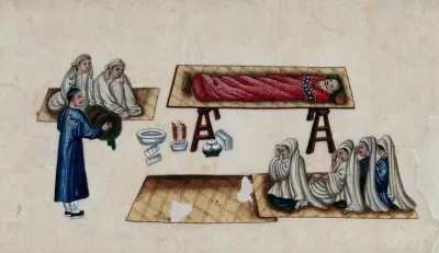 A Chinese funeral scene: male and female mourners are shown kneeling beside the body of an old man, who lies on a table