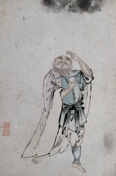A Chinese man holding an egg or cake and looking upwards