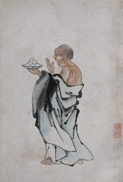 A Chinese man holding cakes on a tray