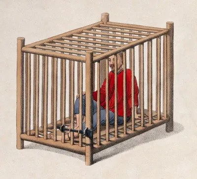 A Chinese man is seated in a wooden cage