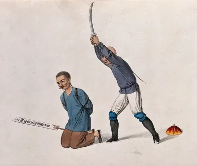 A Chinese man kneeling on the ground is about to be beheaded with a sword