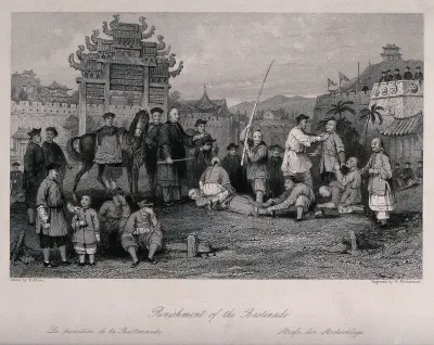 A Chinese man lying on the ground, with a man seated on his back and another holding his feet, is being beaten