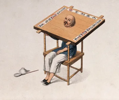 A Chinese man seated in a pillory (cangue)