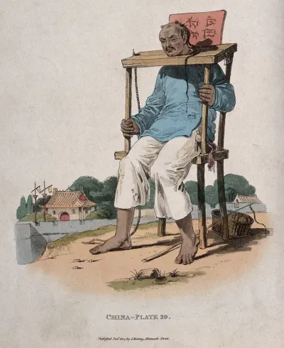 A Chinese man seated with his neck fastened in a cangue or pillory; a whip at his feet and houses in the background