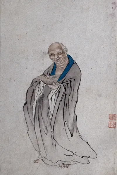 A Chinese man standing holding a long bowl with raised ends