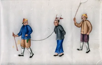 A Chinese man, with hands tied behind his back and a chain attached to his neck, is led by one man, while another hits him from behind with a stick