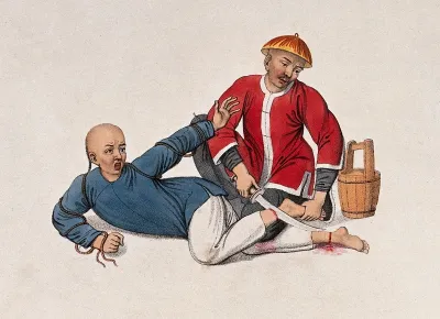 A Chinese prisoner who has tried to escape is lying on the ground while a man wearing a red jacket is cutting his ankles with a sword