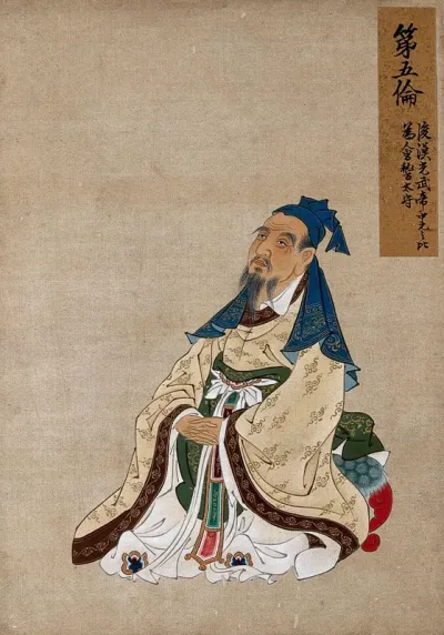 A Chinese seated figure with grey beard and blue hat
