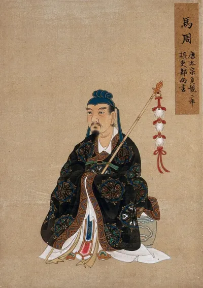 A Chinese seated figure with ornamental bamboo staff and head-dress