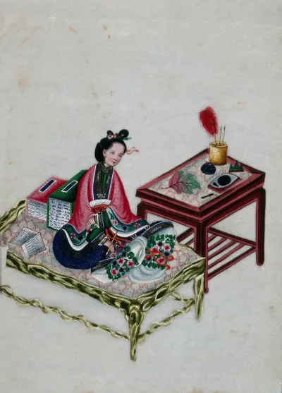 A Chinese woman seated on a bed with writing implements