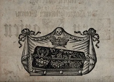 A coffin decorated with skulls and wreaths of flowers