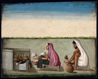 A couple preparing tandoori rotis: the woman faces the tandoor and shapes the bread with her hands as she nurses her baby, whilst the man kneeds the dough