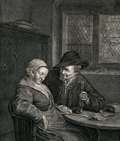 A couple sitting at a table: the man holds a glass in one hand, with the other he holds the woman's hand which is resting on the table with a pipe