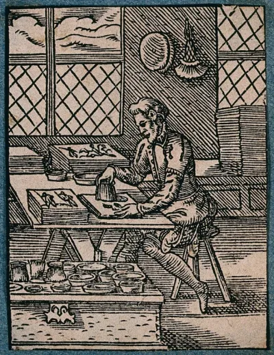 A craftsman illuminating a document