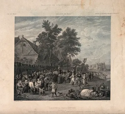 A crowd are gathered on a village green, some are dancing to the tune of the fiddler standing on a barrel, and some are eating and drinking at the tables