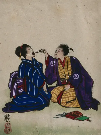 A doctor examining a woman's mouth; doctor and patient are kneeling on the floor