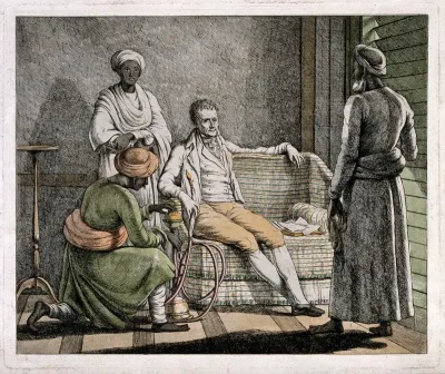 A European gentleman smoking a hooka and being attended to by Asian men