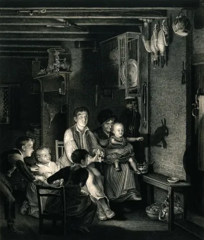 A family sit together in the darkened kitchen where the children are amused by their father making animal shadows in the light shining on the wall